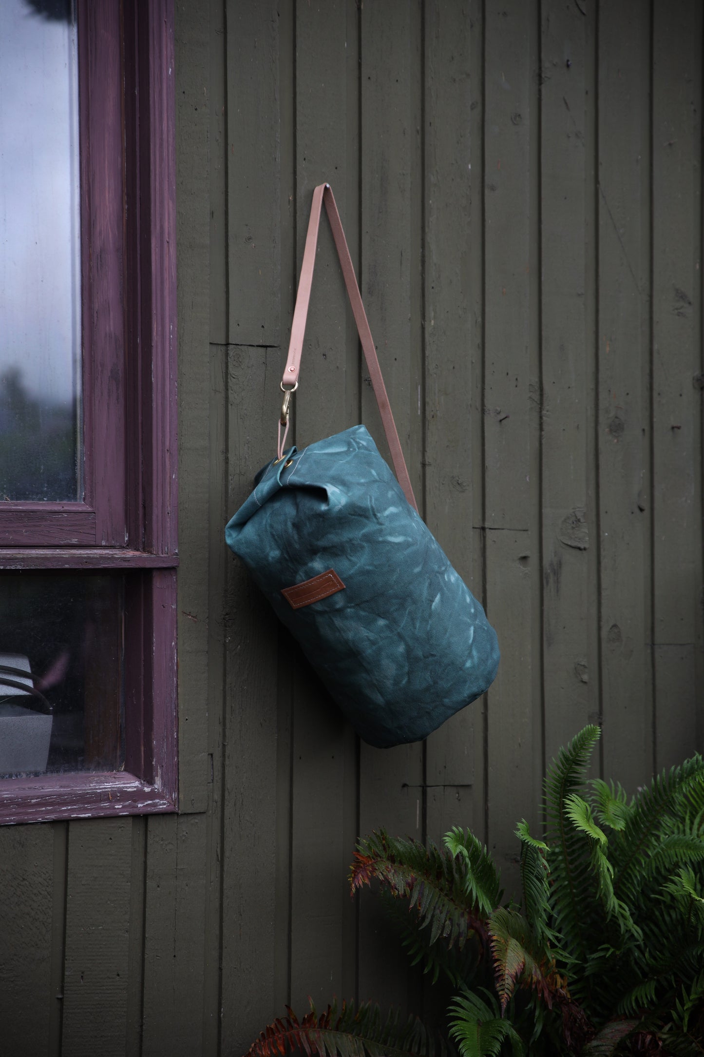 The Runabout in Emerald Waxed Canvas and Veg Tan Leather with Pre-added Patina